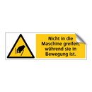 Nicht in die Maschine greifen, während sie in Bewegung ist.