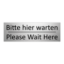 Bitte hier warten - Please Wait Here