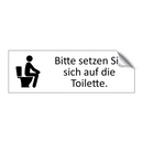 Bitte setzen Sie sich auf die Toilette.