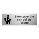 Bitte setzen Sie sich auf die Toilette.
