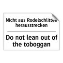 Nicht aus Rodelschlitten herausstrecken/.../ - Do not lean out of the toboggan/.../