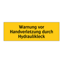 Warnung vor Handverletzung durch Hydraulikleck