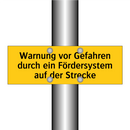 Warnung vor Gefahren durch ein Fördersystem auf der Strecke