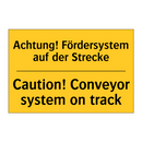 Achtung! Fördersystem auf der /.../ - Caution! Conveyor system on track/.../