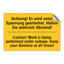 Achtung! Es wird unter Spannung /.../ - Caution! Work is being performed /.../