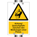 Achtung! Quetschgefahr zwischen den Werkzeugen einer Presse.