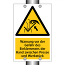 Warnung vor der Gefahr des Einklemmens der Hand zwischen Presse und Werkstück