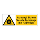 Achtung! Sichern Sie alle Fahrzeuge mit Radkeilen.