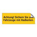 Achtung! Sichern Sie alle Fahrzeuge mit Radkeilen.